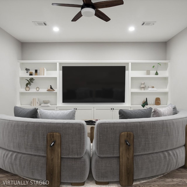 living area featuring wood finished floors, visible vents, and a ceiling fan