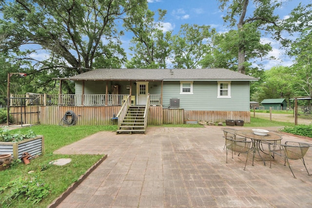 8335 Jernigan Rd, Conroe, TX 77306 - back of property featuring central AC unit, a patio area, and stairway