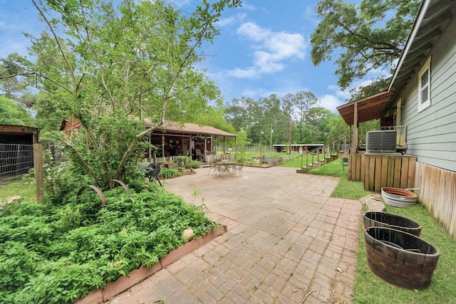 8335 Jernigan Rd, Conroe, TX 77306 - view of patio featuring central AC and stairway