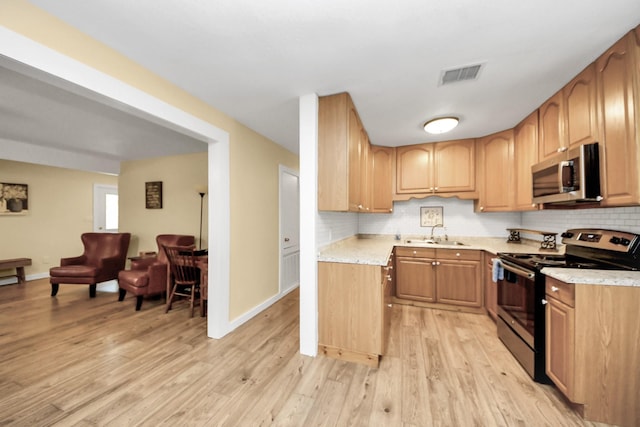 8335 Jernigan Rd, Conroe, TX 77306 - kitchen featuring visible vents, appliances with stainless steel finishes, tasteful backsplash, light countertops, and light wood-style floors