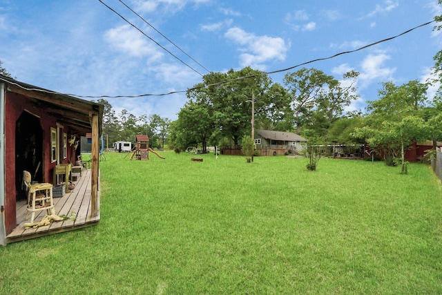 8335 Jernigan Rd, Conroe, TX 77306 - view of yard featuring a deck, a playground, and fence