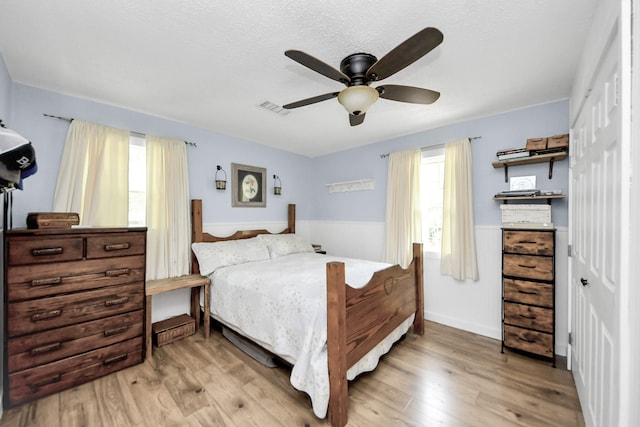 8335 Jernigan Rd, Conroe, TX 77306 - bedroom featuring ceiling fan, wood finished floors, and visible vents