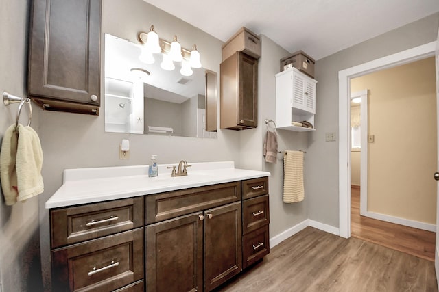 8335 Jernigan Rd, Conroe, TX 77306 - bathroom with vanity, visible vents, wood finished floors, and baseboards