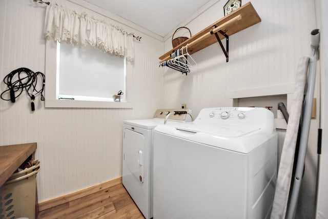 8335 Jernigan Rd, Conroe, TX 77306 - clothes washing area featuring baseboards, laundry area, light wood-style flooring, and independent washer and dryer