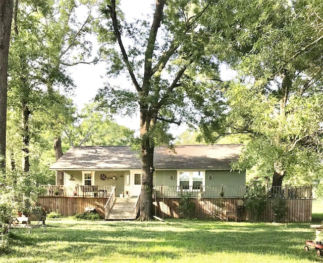 8335 Jernigan Rd, Conroe, TX 77306 - rear view of house with fence, a wooden deck, a chimney, and a yard