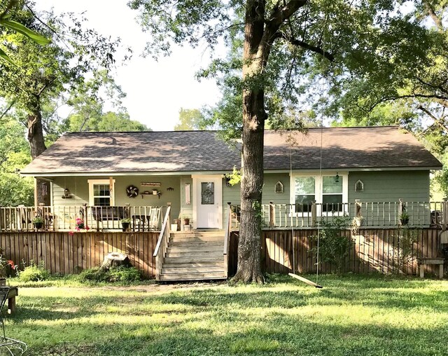 8335 Jernigan Rd, Conroe, TX 77306 - rear view of house with a yard and roof with shingles