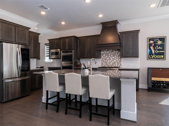 19103 Timpson Dr, Cypress, TX 77433 - kitchen with appliances with stainless steel finishes, custom exhaust hood, a sink, ornamental molding, and decorative backsplash