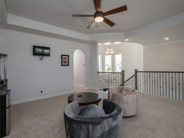 19103 Timpson Dr, Cypress, TX 77433 - living area with a ceiling fan, carpet floors, a chandelier, arched walkways, and baseboards