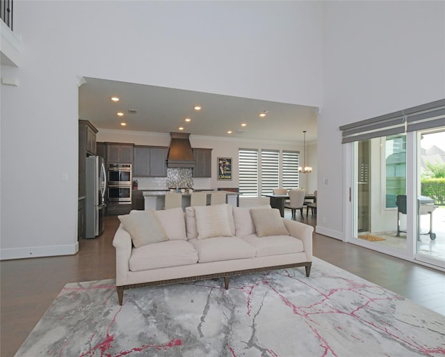 19103 Timpson Dr, Cypress, TX 77433 - living area featuring plenty of natural light, recessed lighting, a towering ceiling, dark wood finished floors, and crown molding