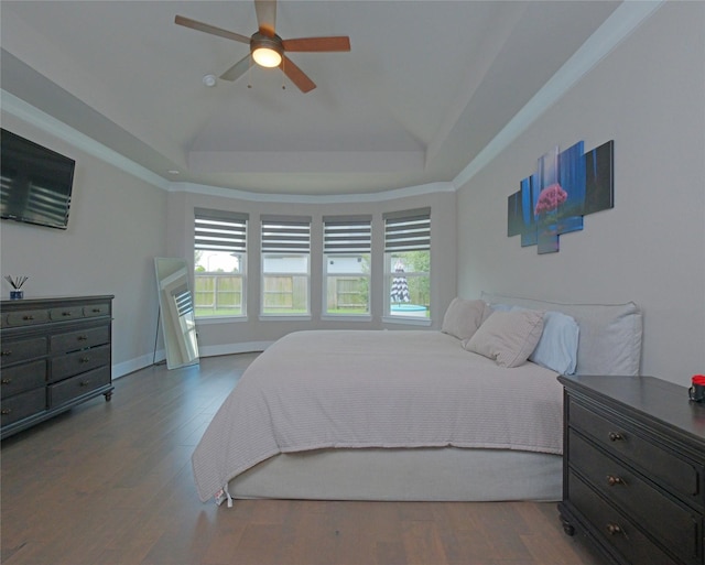 19103 Timpson Dr, Cypress, TX 77433 - bedroom with a raised ceiling, wood finished floors, and a ceiling fan