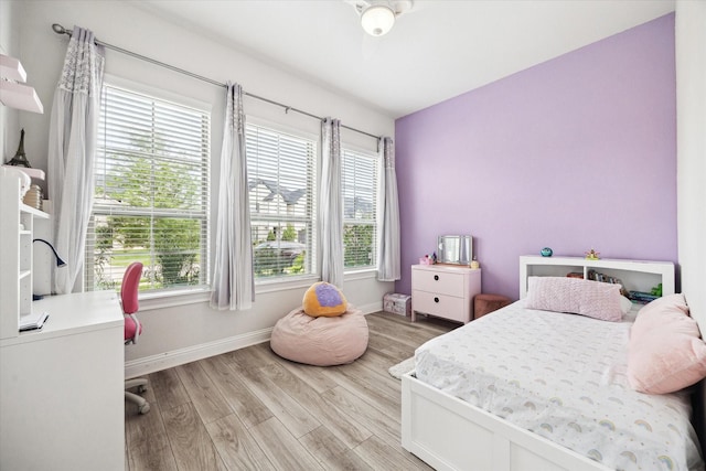 29035 Nectar Island Ln, Katy, TX 77494 - bedroom with multiple windows, light wood-style flooring, and baseboards