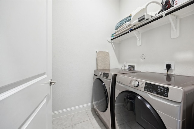 29035 Nectar Island Ln, Katy, TX 77494 - washroom with washer and clothes dryer, light tile patterned floors, and baseboards