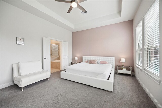 29035 Nectar Island Ln, Katy, TX 77494 - bedroom with multiple windows, carpet flooring, a raised ceiling, and ensuite bathroom