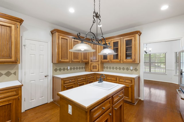 kitchen with a sink, light countertops, and brown cabinetry