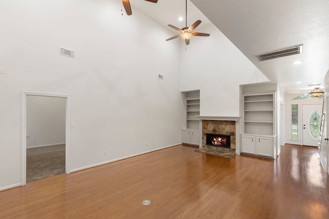 unfurnished living room featuring visible vents, high vaulted ceiling, a ceiling fan, and wood finished floors