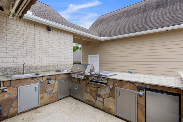 view of patio / terrace featuring a sink, area for grilling, and an outdoor kitchen