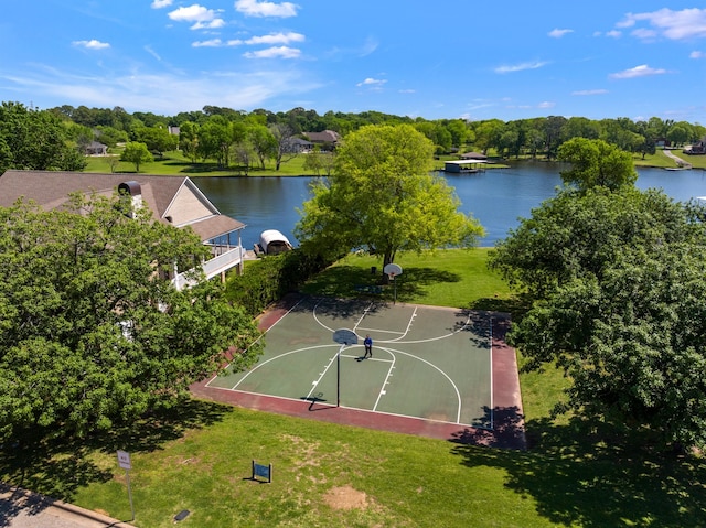 view of basketball court featuring a water view, community basketball court, and a lawn