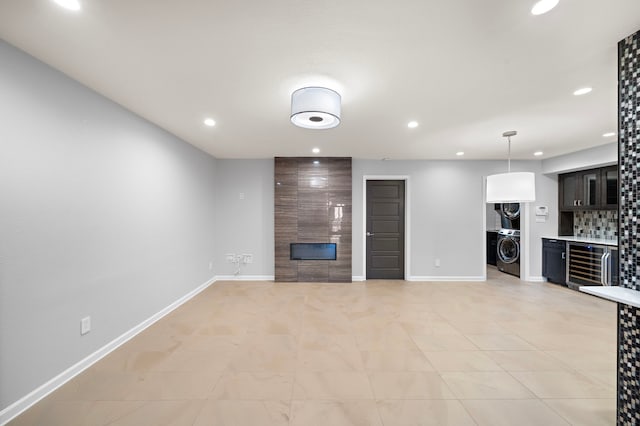8954 Chatsworth Dr, Houston, TX 77024 - unfurnished living room with a large fireplace, beverage cooler, baseboards, recessed lighting, and a dry bar
