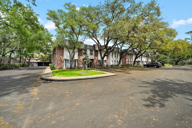 8954 Chatsworth Dr, Houston, TX 77024 - view of front of property with brick siding and uncovered parking
