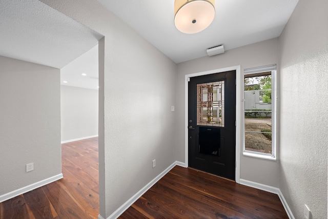 8954 Chatsworth Dr, Houston, TX 77024 - foyer entrance with wood finished floors, baseboards, and a textured wall