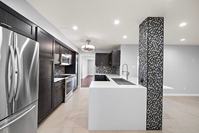 8954 Chatsworth Dr, Houston, TX 77024 - kitchen with appliances with stainless steel finishes, a sink, decorative backsplash, light tile patterned flooring, and light countertops