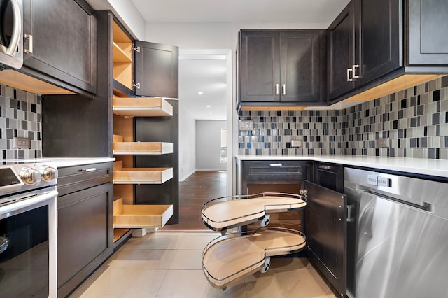 8954 Chatsworth Dr, Houston, TX 77024 - kitchen with stainless steel appliances, open shelves, light countertops, tasteful backsplash, and light tile patterned flooring