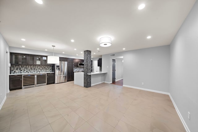 8954 Chatsworth Dr, Houston, TX 77024 - kitchen featuring stainless steel refrigerator with ice dispenser, beverage cooler, backsplash, light countertops, and dark brown cabinetry