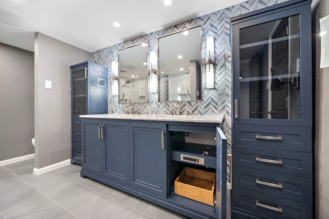 8954 Chatsworth Dr, Houston, TX 77024 - bathroom with tile patterned floors, backsplash, vanity, toilet, and baseboards
