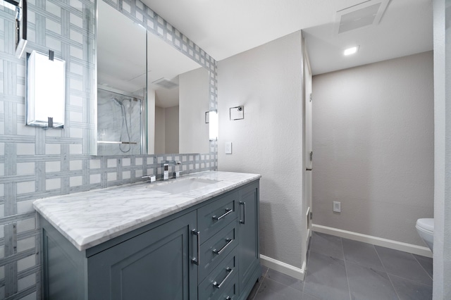 8954 Chatsworth Dr, Houston, TX 77024 - full bathroom with tile patterned flooring, vanity, toilet, baseboards, and a shower with shower door