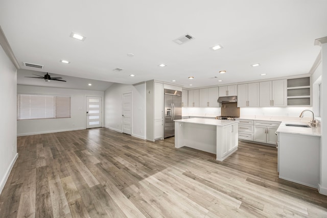 4626 Ella Blvd, Houston, TX 77018 - kitchen featuring a sink, built in refrigerator, under cabinet range hood, open floor plan, and open shelves
