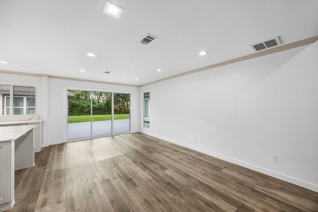 4626 Ella Blvd, Houston, TX 77018 - unfurnished living room with ornamental molding, baseboards, wood finished floors, and recessed lighting