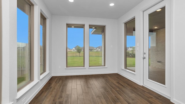 unfurnished sunroom featuring french doors, wood finished floors, recessed lighting, and baseboards