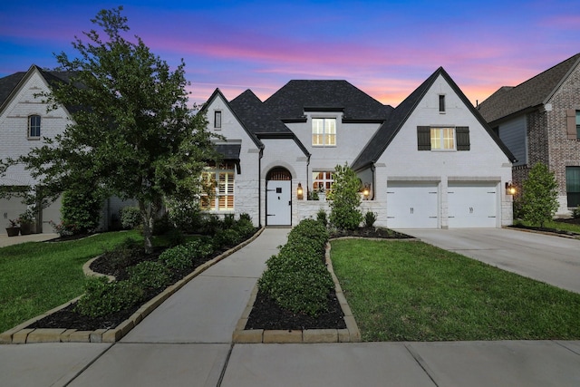 2514 Heritage Park Dr, Missouri City, TX 77459 - french country home with driveway, stone siding, a shingled roof, a front yard, and a garage