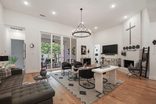 2514 Heritage Park Dr, Missouri City, TX 77459 - living room featuring recessed lighting, light wood-style flooring, a brick fireplace, baseboards, and visible vents