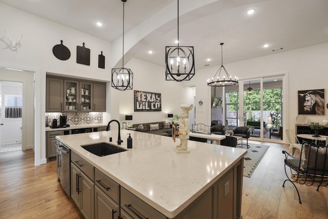 2514 Heritage Park Dr, Missouri City, TX 77459 - kitchen with light wood-style flooring, dishwasher, a sink, visible vents, and open floor plan