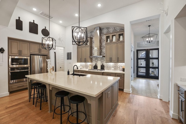 2514 Heritage Park Dr, Missouri City, TX 77459 - kitchen featuring a chandelier, visible vents, stainless steel appliances, and wall chimney exhaust hood