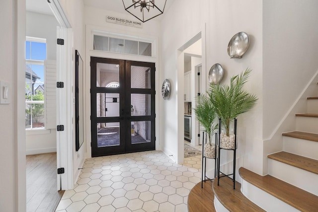 2514 Heritage Park Dr, Missouri City, TX 77459 - entrance foyer featuring an inviting chandelier, stairway, french doors, and beverage cooler