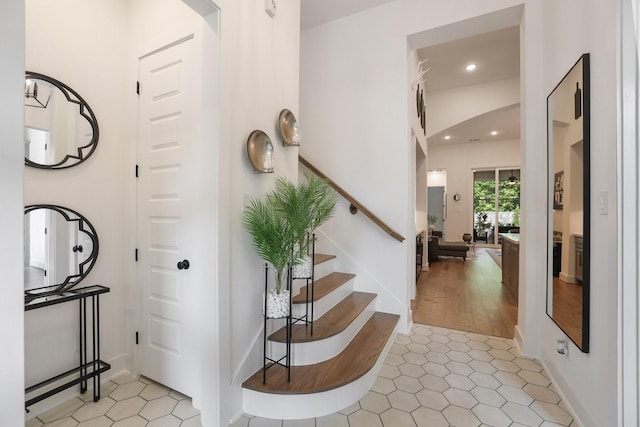 2514 Heritage Park Dr, Missouri City, TX 77459 - foyer entrance with light tile patterned floors, recessed lighting, arched walkways, and stairway