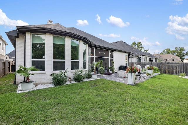 2514 Heritage Park Dr, Missouri City, TX 77459 - back of house featuring a patio, a chimney, a yard, brick siding, and a fenced backyard