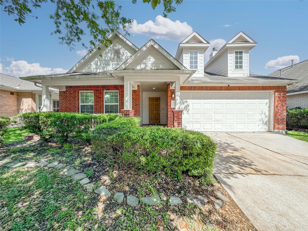 8519 Riverbend Canyon Ln, Houston, TX 77089 - view of front of property with an attached garage, driveway, and brick siding