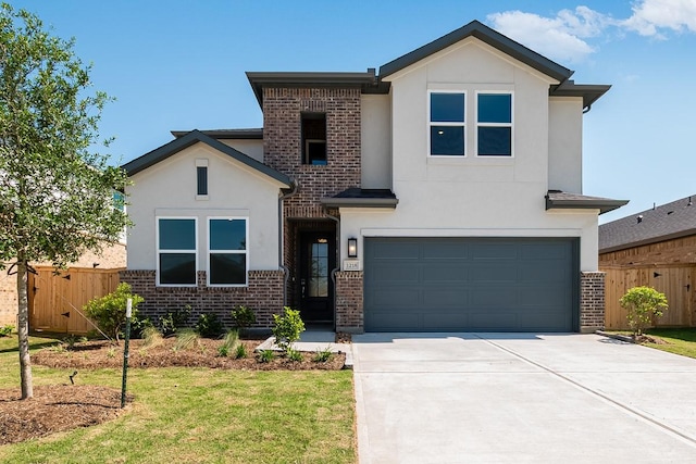 view of front facade with stucco siding, brick siding, fence, and a garage