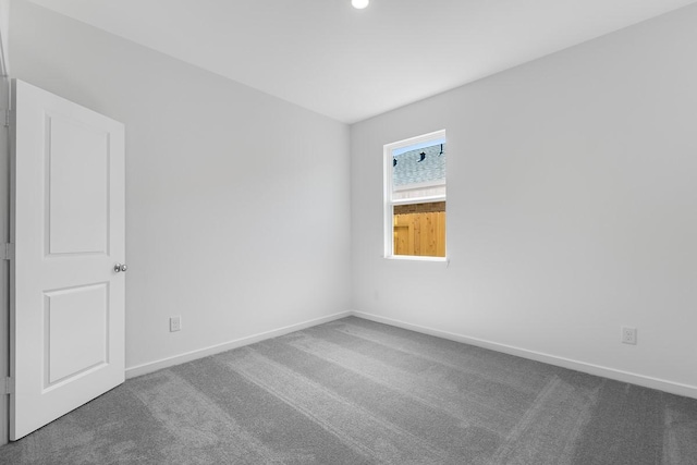 spare room featuring recessed lighting, carpet floors, and baseboards