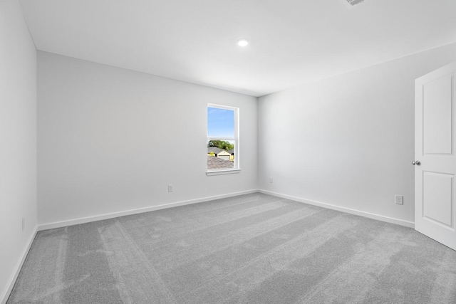 spare room featuring visible vents, baseboards, carpet, and recessed lighting