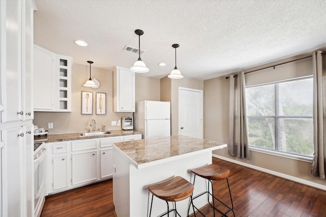 3650 Ward Bend Rd, Sealy, TX 77474 - kitchen with visible vents, a sink, white appliances, dark wood finished floors, and white cabinetry