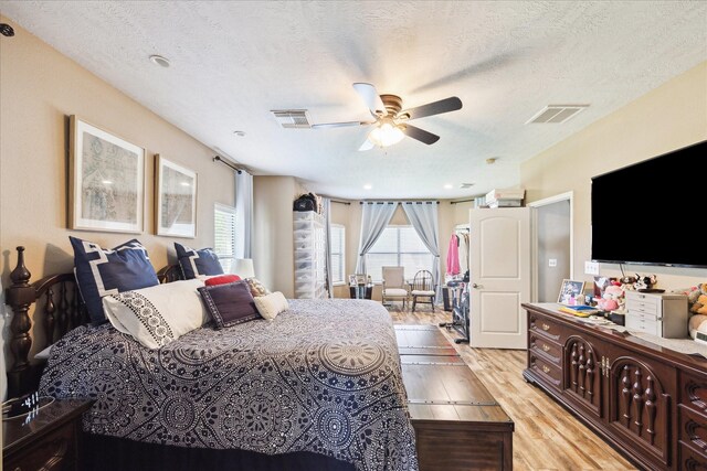 3650 Ward Bend Rd, Sealy, TX 77474 - bedroom with visible vents, light wood-style flooring, and multiple windows
