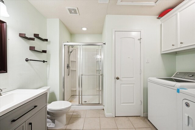 3650 Ward Bend Rd, Sealy, TX 77474 - bathroom featuring visible vents, independent washer and dryer, vanity, tile patterned floors, and a stall shower