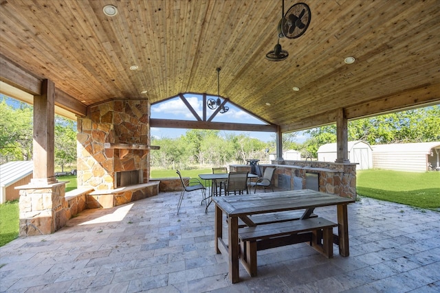 3650 Ward Bend Rd, Sealy, TX 77474 - view of patio featuring outdoor dining space, a shed, and an outdoor stone fireplace