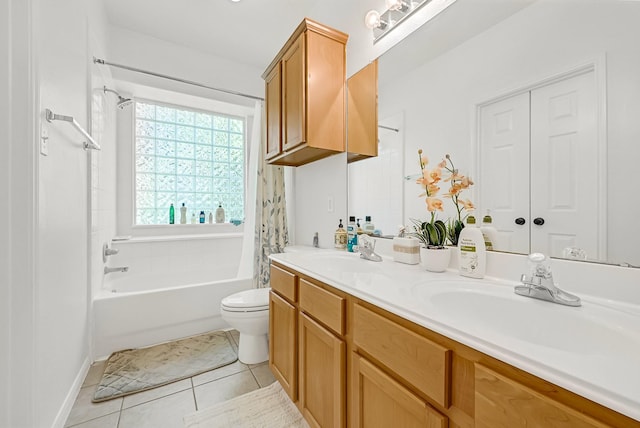 full bathroom featuring a sink, tile patterned floors, double vanity, and toilet