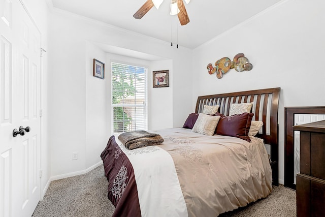 carpeted bedroom with ornamental molding, baseboards, and a ceiling fan