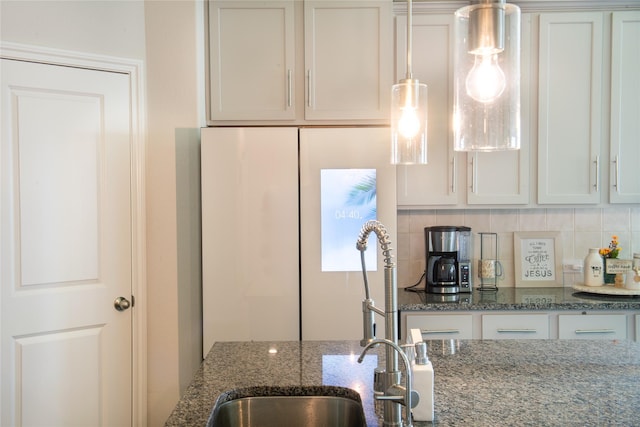 835 Sarasota Shore Dr, Katy, TX 77493 - kitchen with dark stone counters, decorative backsplash, freestanding refrigerator, and white cabinets